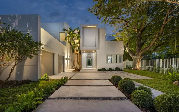Newly built contemporary home with a lit front path